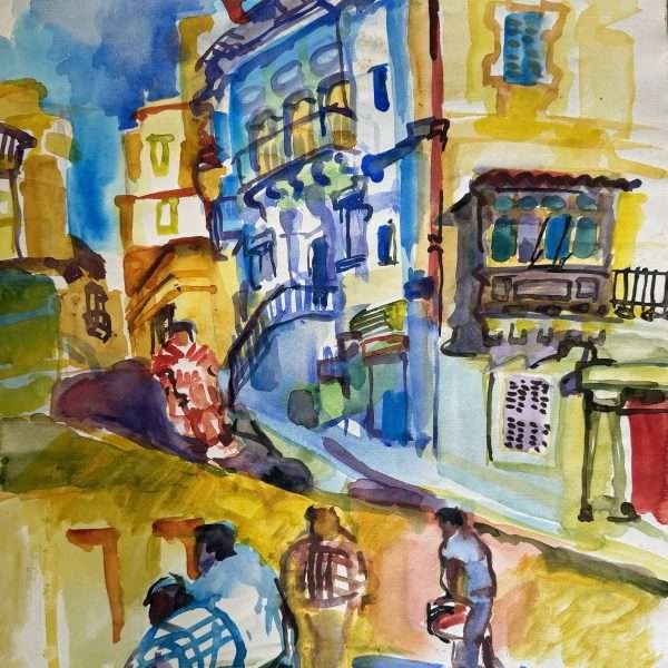 BNF bank building St Julians by Olaug Vethal is a bright watercolour painting on paper depicting a street in St Julians. It appears to be a street that takes you down to Spinola Bay from Sliema and in the middle is a blue building with a German and Maltese flag on the roof and on either side. People are seen walking across and the sky depicted at the top left is bright blue.