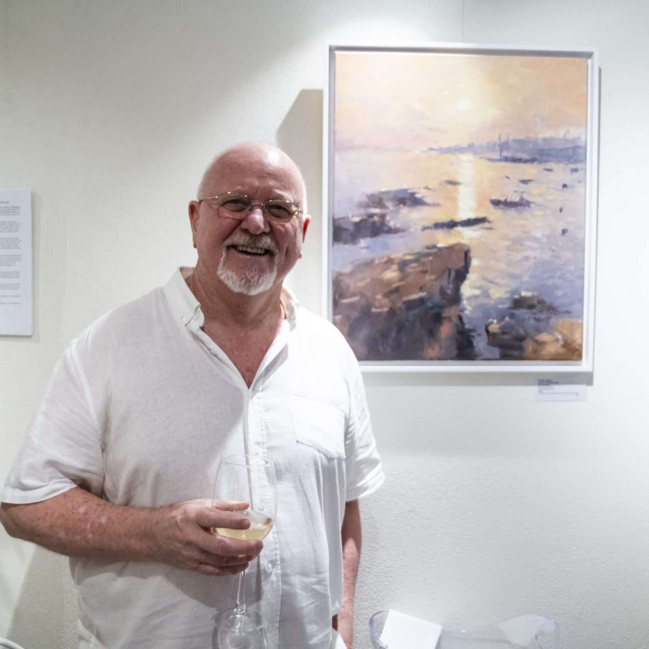 Anthony Weitz in front of his painting at his exhibition 'Chasing the Light: Malta En Plein Air' 2025. Image courtesy of Jacob Sammut